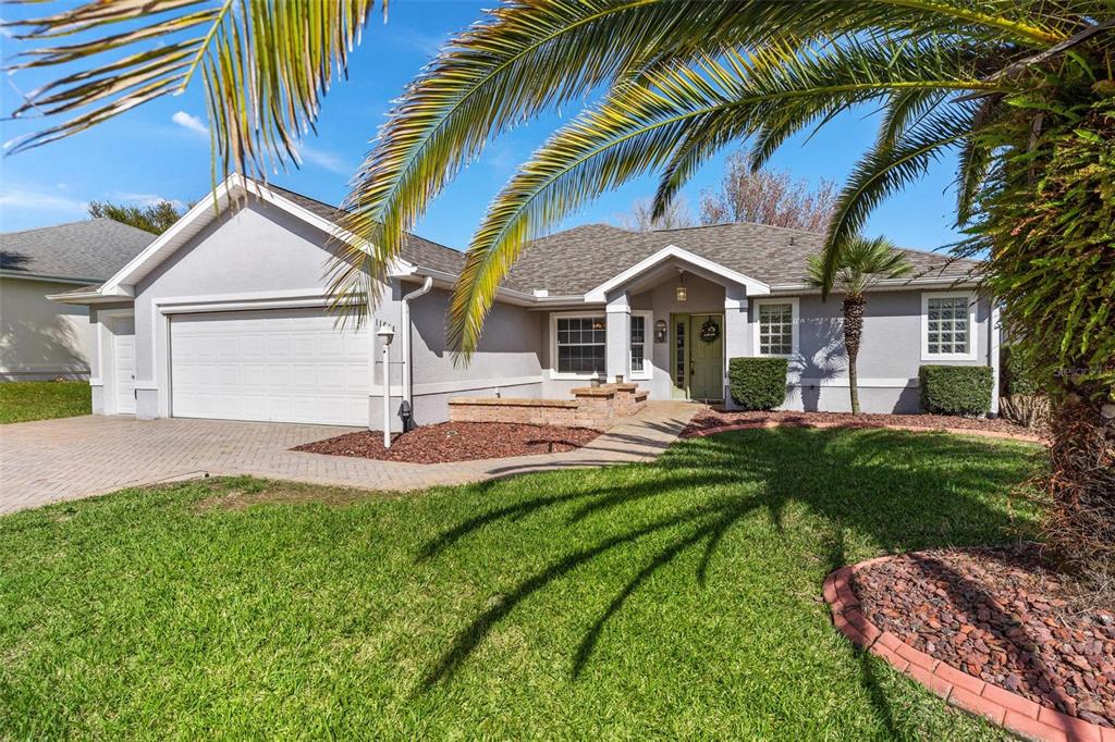 11614 Southeast 172nd Loop Summerfield, FL 34491 - Photo 54 of 55 a front view of a house with a yard and palm trees