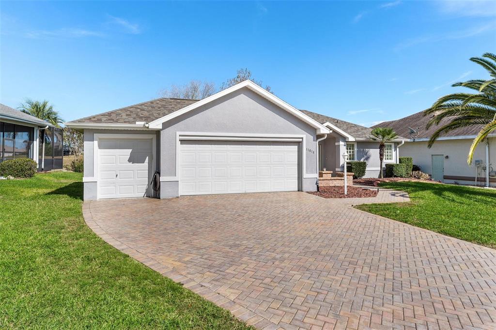 11614 Southeast 172nd Loop Summerfield, FL 34491 - Photo 55 of 55 a view of a house with a yard and garage