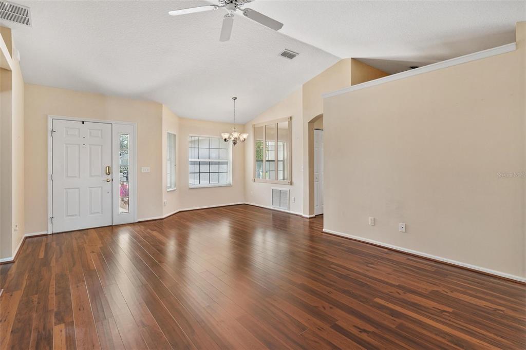 11614 Southeast 172nd Loop Summerfield, FL 34491 - Photo 7 of 55 wooden floor in an empty room with a window