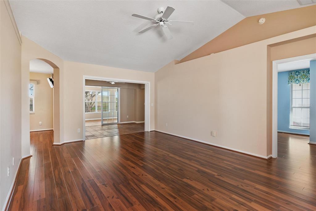 11614 Southeast 172nd Loop Summerfield, FL 34491 - Photo 10 of 55 wooden floor in an empty room with a window