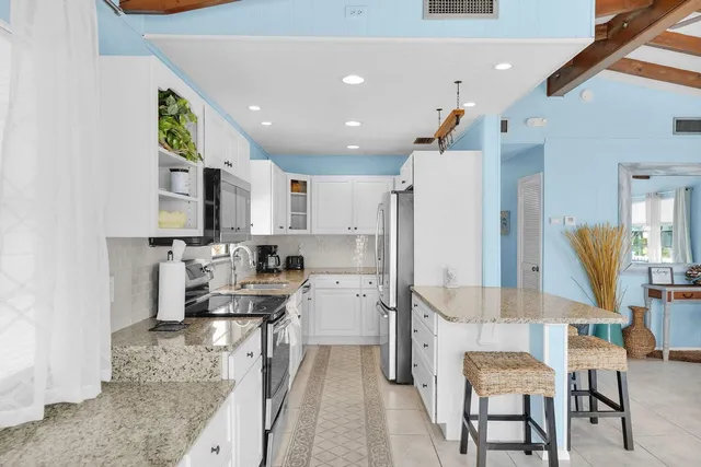 a kitchen with a sink stove top oven and refrigerator