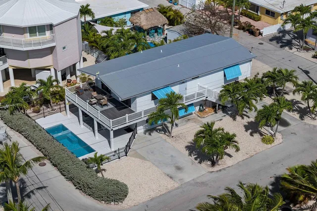 an aerial view of a house with garden space and street view