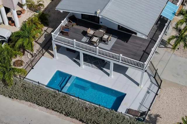 an aerial view of a house with garden space and lake view