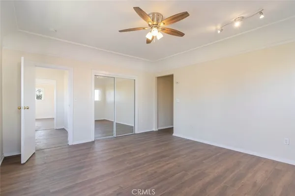a view of an empty room and wooden floor