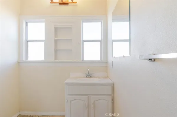 a bathroom with a sink a vanity and a mirror
