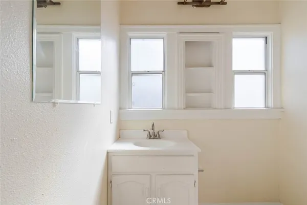 a bathroom with a sink a vanity and a window