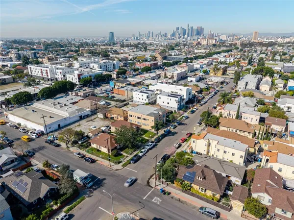 an aerial view of residential houses with outdoor space and parking