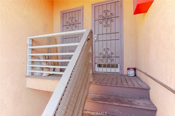 a view of staircase with white walls and wooden floor