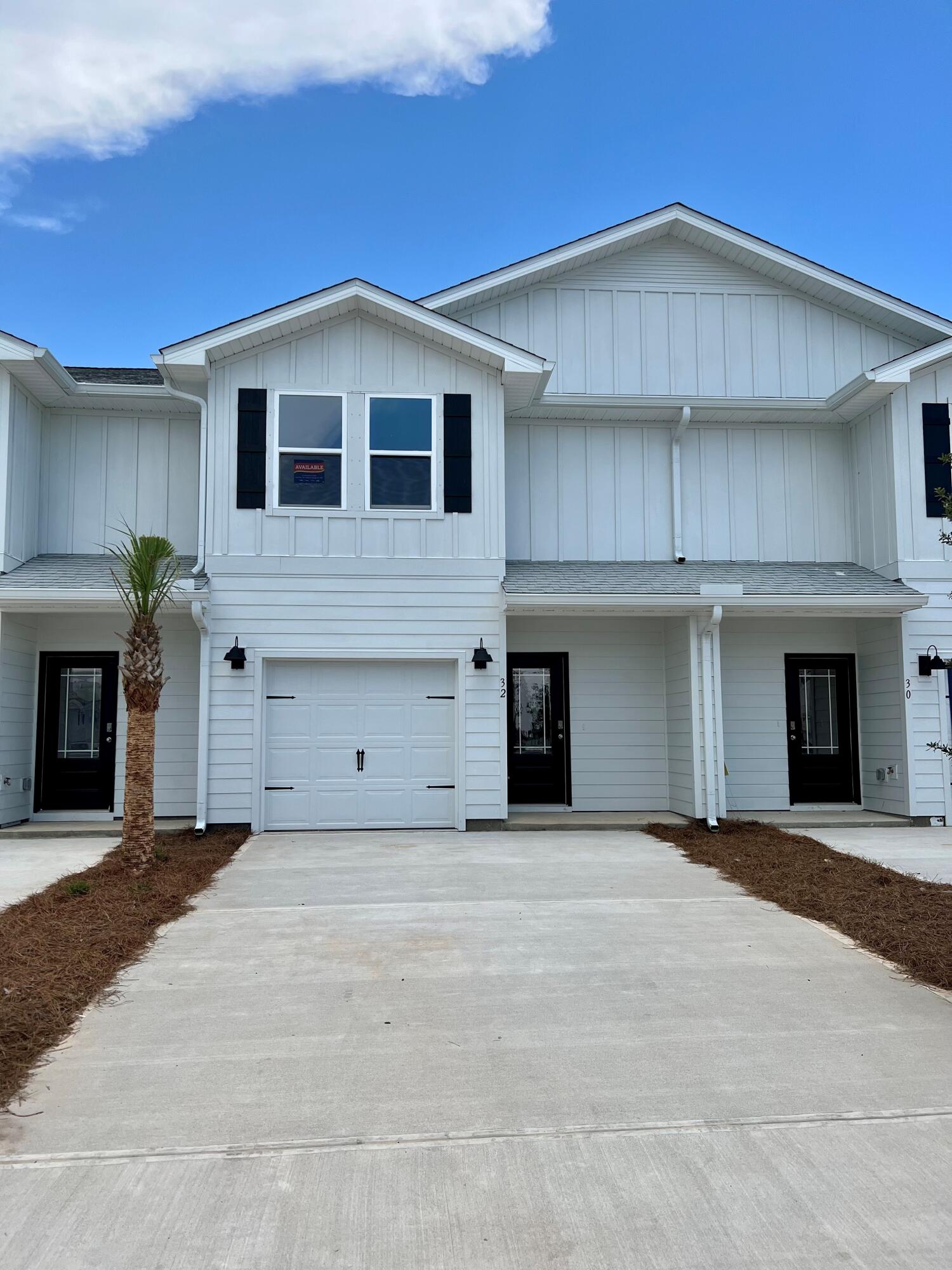 28 Redbird Loop Destin, FL 32541 - Photo 1 of 23 a front view of a house with yard and garage