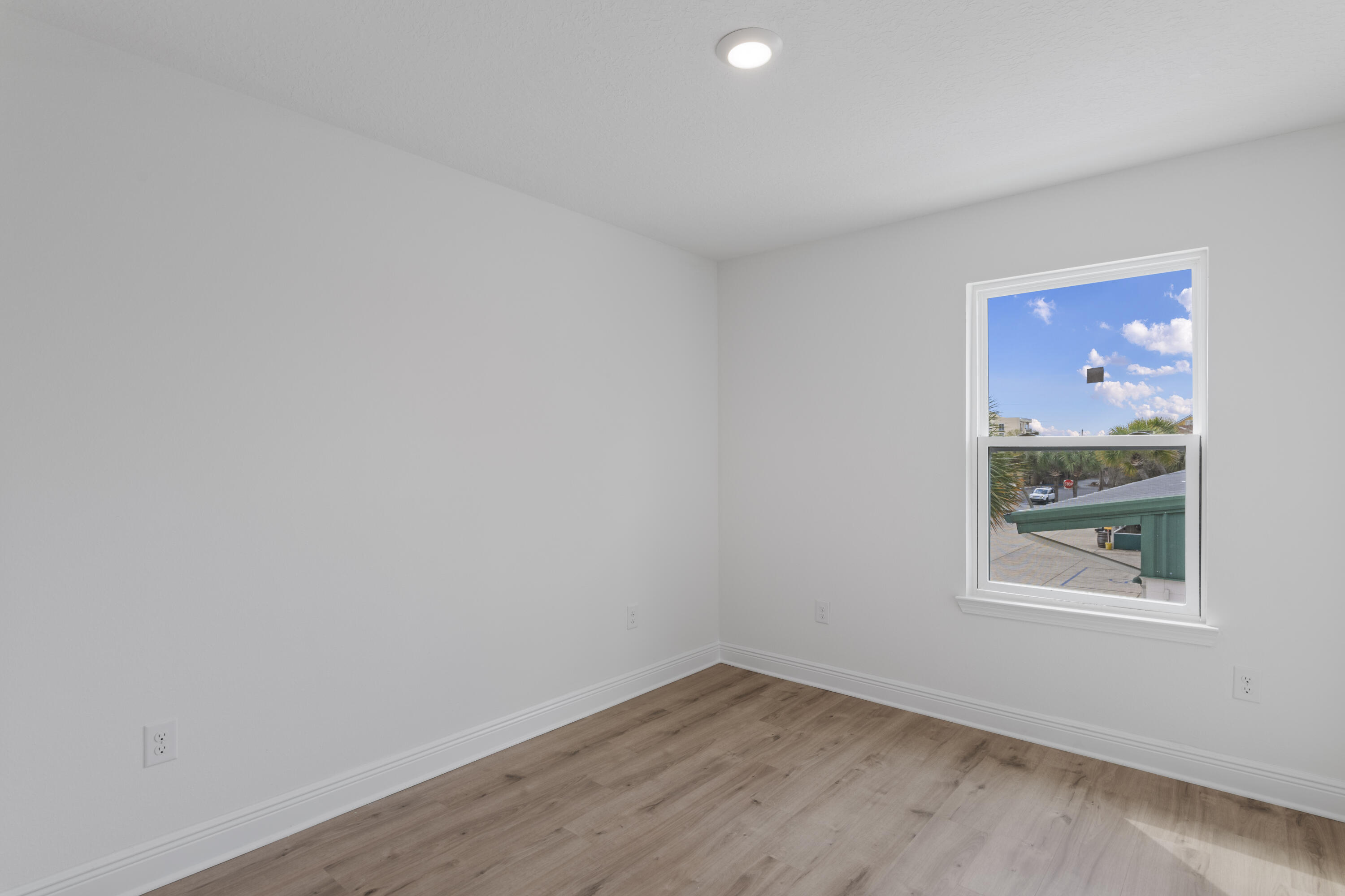 28 Redbird Loop Destin, FL 32541 - Photo 18 of 23 a view of an empty room with wooden floor and a window