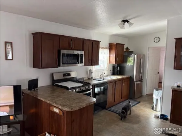 a kitchen with granite countertop a sink appliances and cabinets