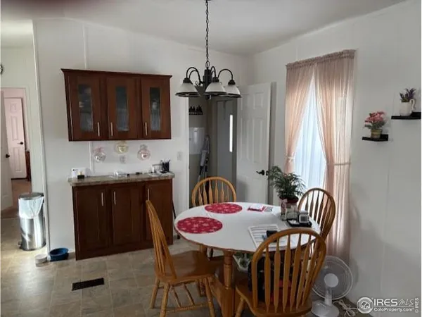 a dining room with furniture and window