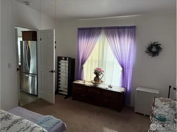 a bed room with a bed and a window