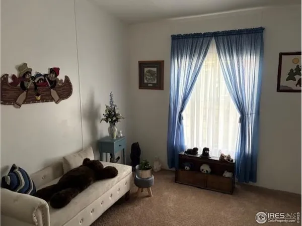 a bedroom with bed couch and window