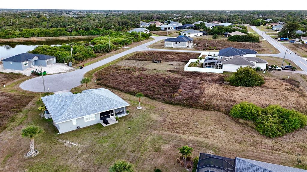 116 Temper Lane Rotonda West, FL 33947 - Photo 6 of 6 an aerial view of a house with a yard basket ball court and a lake view