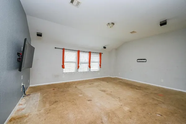 a bathroom with a granite countertop sink a toilet a mirror and shower