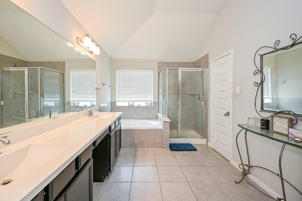 7007 Flewellen Falls Lane Spring, TX 77379 - Photo 18 of 20 a bathroom with a granite countertop sink a toilet a mirror and shower
