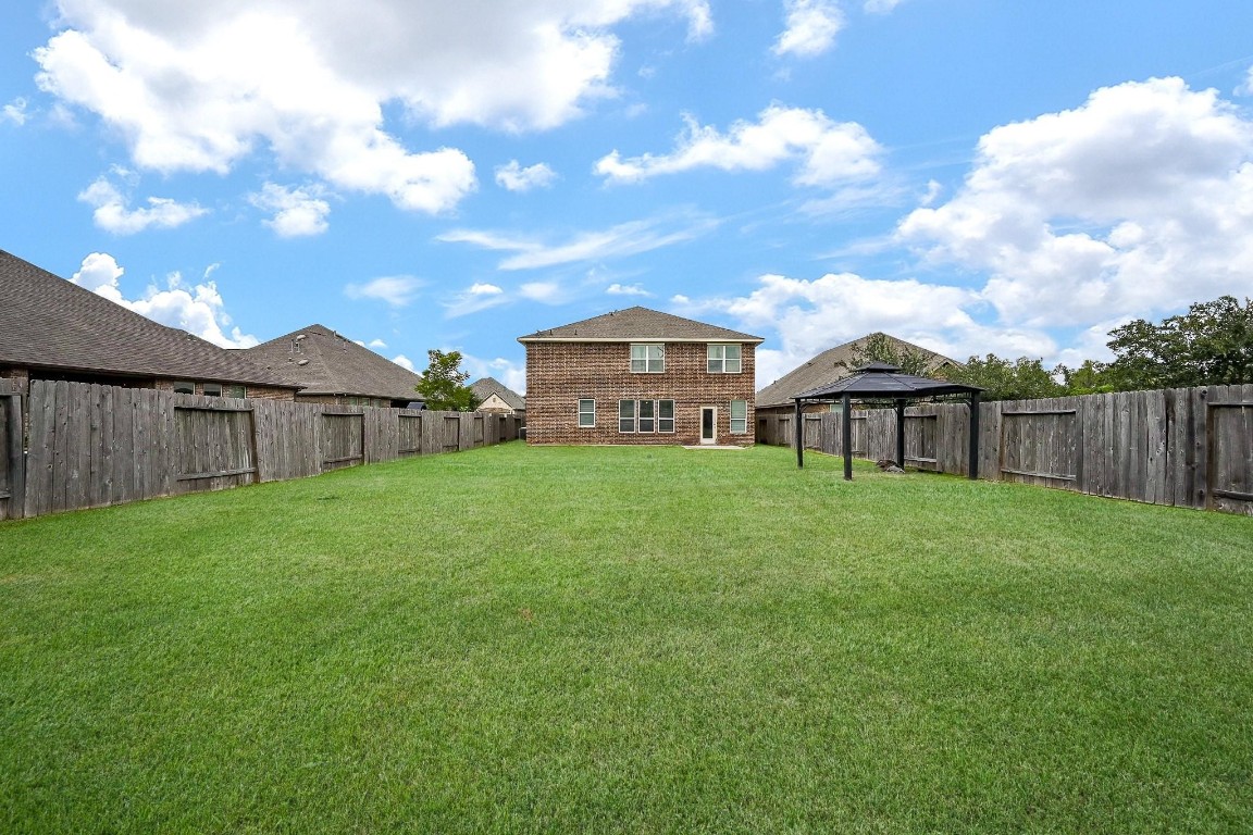 7007 Flewellen Falls Lane Spring, TX 77379 - Photo 19 of 20 a view of a yard in front of a house with a large tree