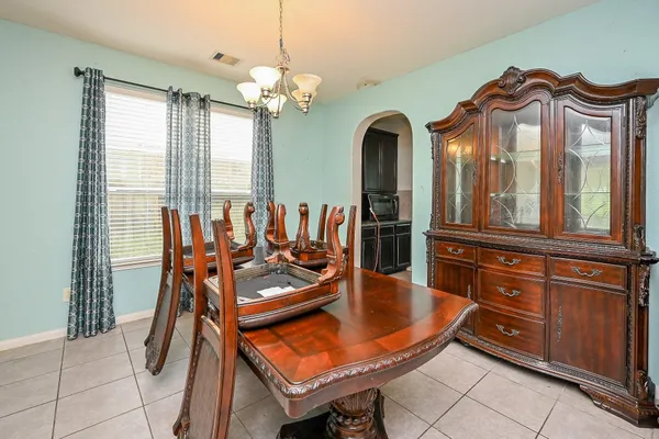 a view of a dining room with furniture and chandelier