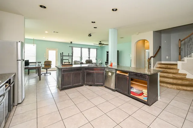 a large white kitchen with a large window