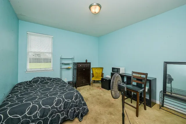 a bedroom with a bed and a chandelier