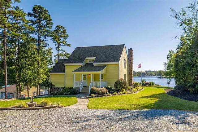 a front view of a house with swimming pool and porch