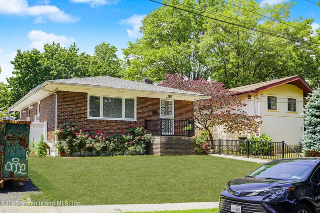 a view of a house with backyard sitting area and garden