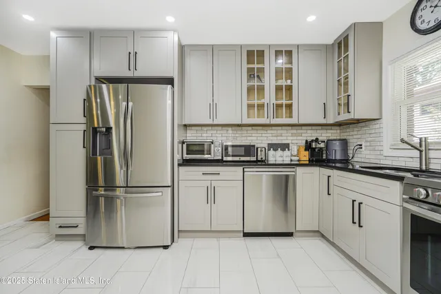 a kitchen with a refrigerator sink and cabinets