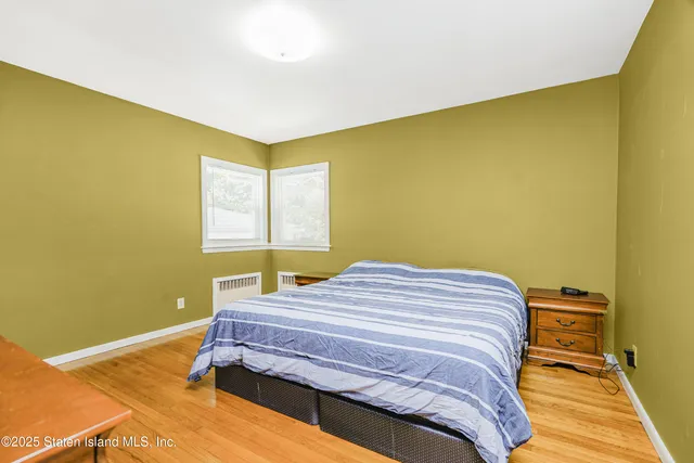 a bedroom with a bed and a television