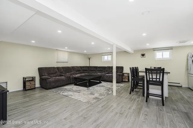 a living room with furniture and a dining table with kitchen view