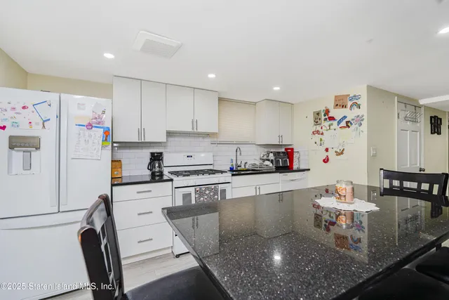a kitchen with furniture and a flat screen tv