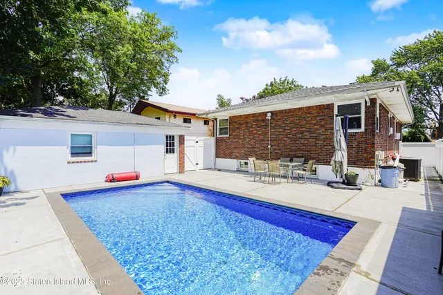 a view of outdoor kitchen and dining area