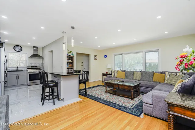 a living room with furniture and kitchen view