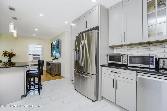 a kitchen with stainless steel appliances a refrigerator stove microwave and cabinets