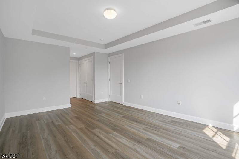 40 West Park Place, Unit 412 Morristown, NJ 07960 - Photo 12 of 32 a view of an empty room with wooden floor