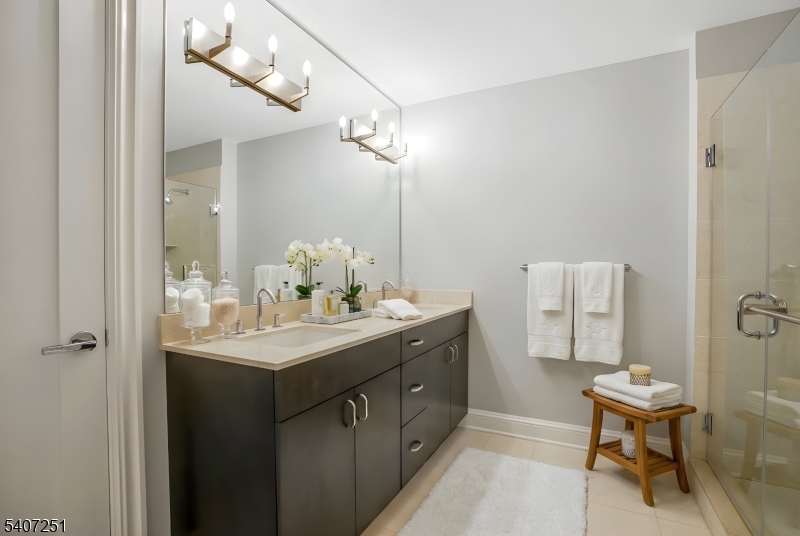 40 West Park Place, Unit 412 Morristown, NJ 07960 - Photo 14 of 32 a bathroom with a sink and a mirror