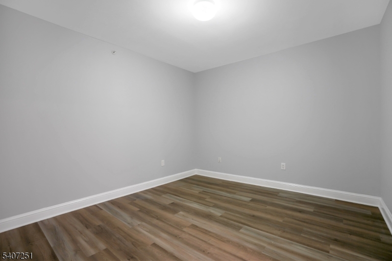 40 West Park Place, Unit 412 Morristown, NJ 07960 - Photo 21 of 32 a view of an empty room with wooden floor