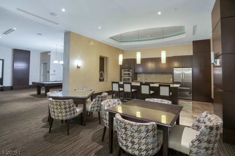 40 West Park Place, Unit 412 Morristown, NJ 07960 - Photo 26 of 32 a dining room with furniture a rug and kitchen view