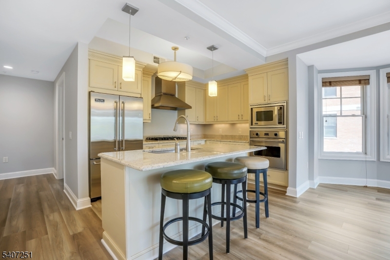 40 West Park Place, Unit 412 Morristown, NJ 07960 - Photo 3 of 32 a kitchen with stainless steel appliances granite countertop a sink a stove and a refrigerator