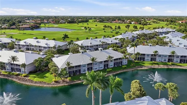 an aerial view of a house with a garden and lake view