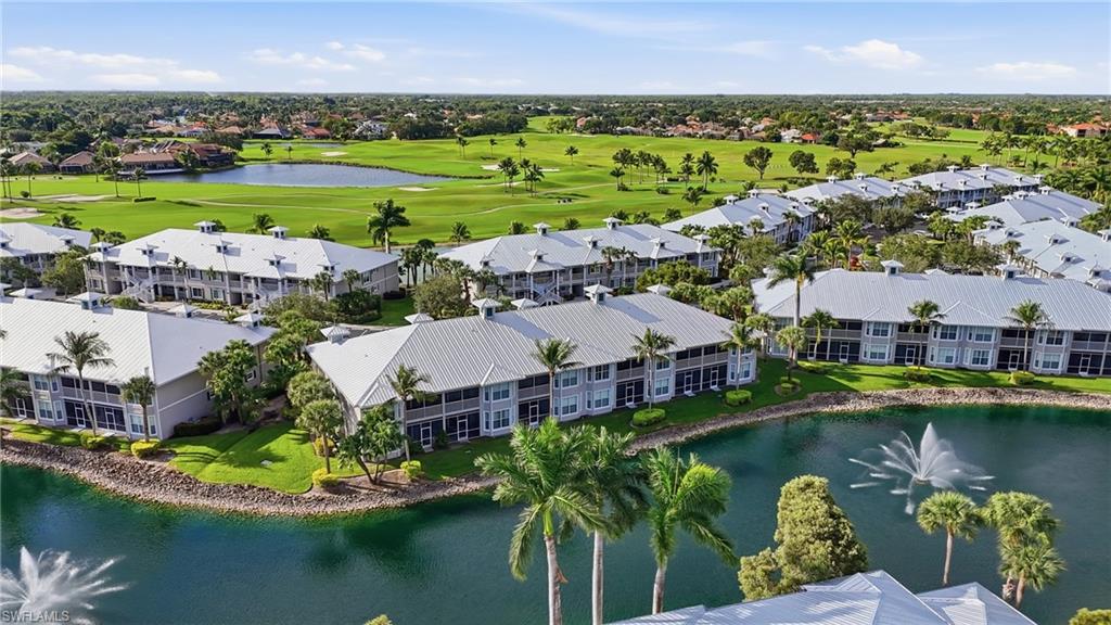 an aerial view of a house with a garden and lake view