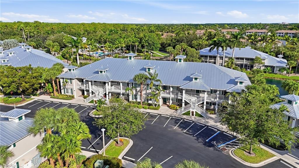7920 Mahogany Run Lane, Unit 1015 Naples, FL 34113 - Photo 13 of 41 an aerial view of multiple houses with a yard