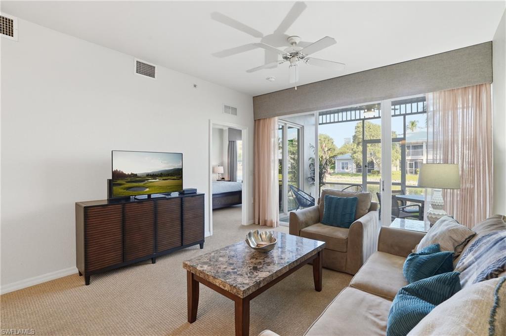 7920 Mahogany Run Lane, Unit 1015 Naples, FL 34113 - Photo 20 of 41 a living room with furniture and a flat screen tv