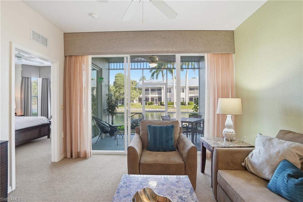 7920 Mahogany Run Lane, Unit 1015 Naples, FL 34113 - Photo 22 of 41 a living room with furniture and a table