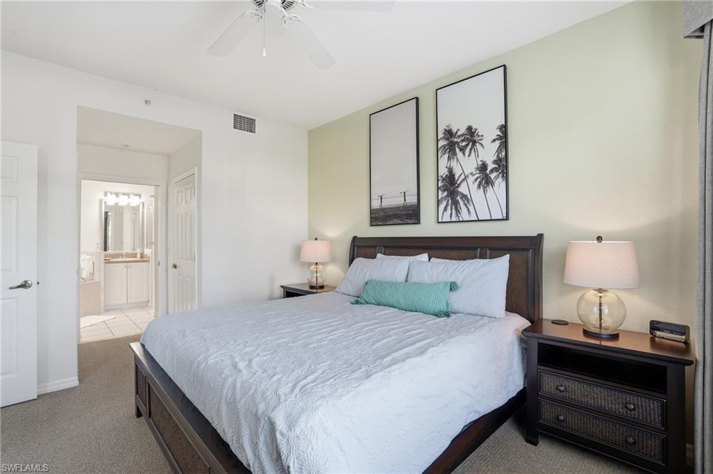 7920 Mahogany Run Lane, Unit 1015 Naples, FL 34113 - Photo 26 of 41 a bedroom with a bed and a painting on the wall