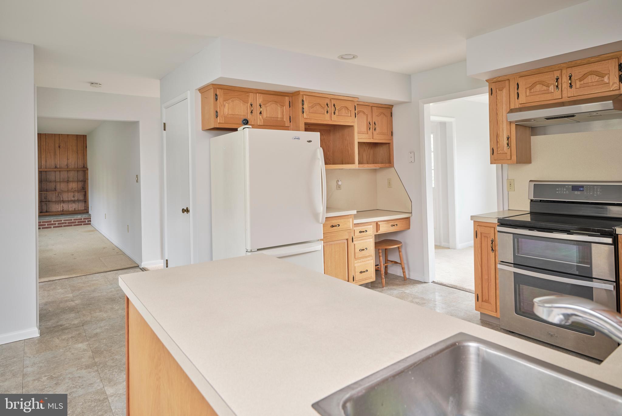 4902 Anderson Road Doylestown, PA 18902 - Photo 20 of 46 a kitchen with a refrigerator and a stove top oven