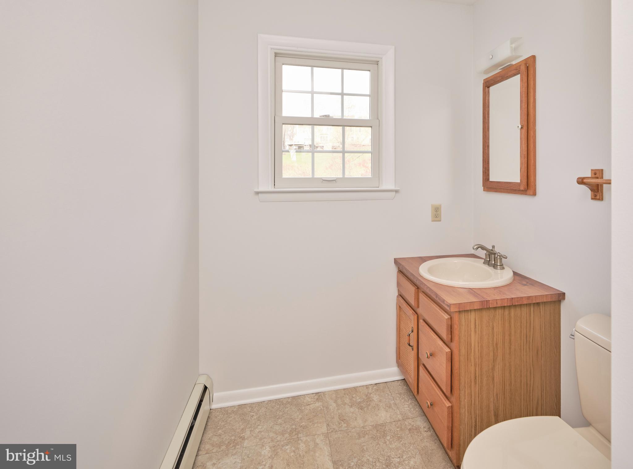 4902 Anderson Road Doylestown, PA 18902 - Photo 22 of 46 a bathroom with a sink a toilet and mirror