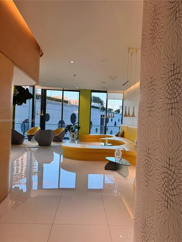 a living room with furniture and large windows