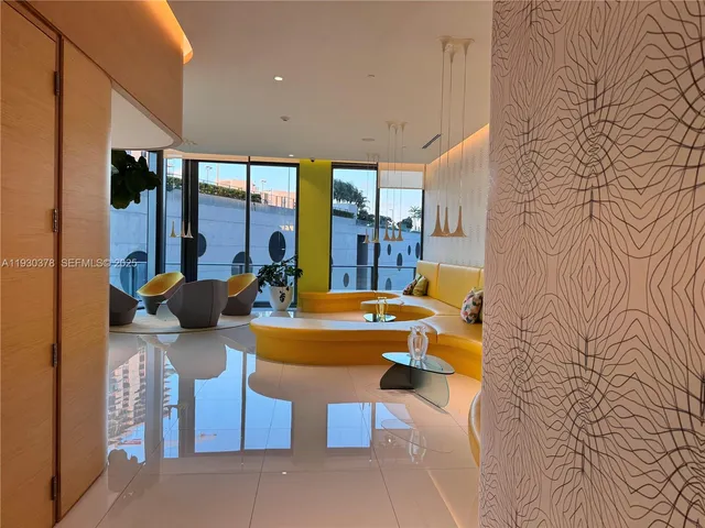 a view of a patio with table and chairs potted plants and wooden floor