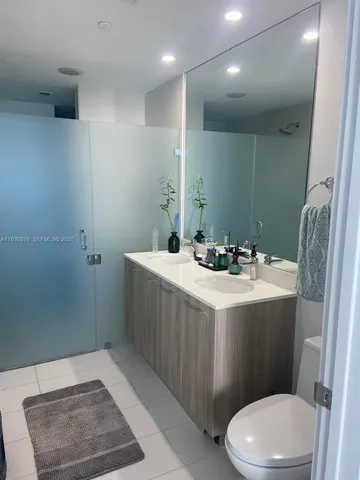 a bathroom with a sink a toilet and a mirror